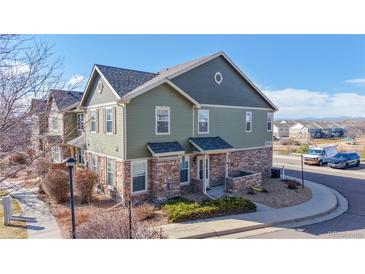 A charming two-story townhome with stone accents and well-maintained landscaping at 12783 Leyden St # E, Thornton, CO 80602