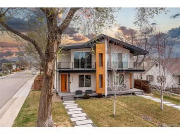 Modern two-story home with a striking design, landscaped front yard, and second-story balconies at 3000 S Elati St, Englewood, CO 80110