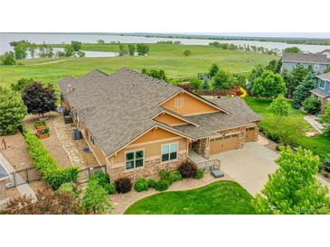 Aerial view of the property showcasing lush landscaping and neighborhood setting at 26631 E Arbor Dr, Aurora, CO 80016