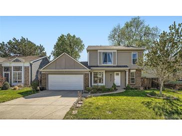Charming two-story home featuring a well-manicured lawn and a two car garage, perfect for a Gathering at 10064 Owens St, Broomfield, CO 80021