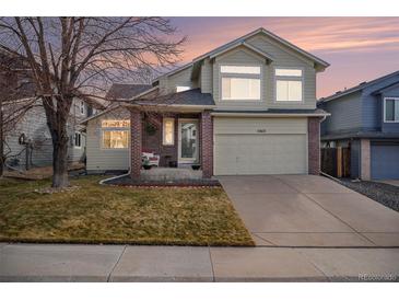 Inviting two-story home boasts a manicured lawn, two-car garage, and appealing curb appeal at 11613 W Coal Mine Dr, Littleton, CO 80127