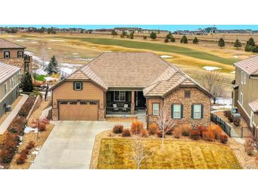 Inviting exterior of a single-Gathering home with a well-manicured front yard and a large, attached two-car garage at 27615 E Moraine Dr, Aurora, CO 80016