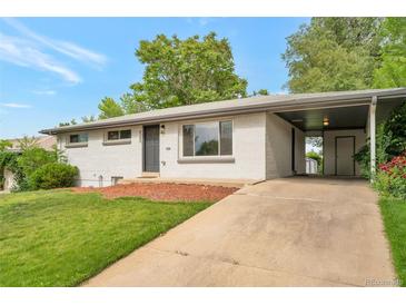 Charming single-story home with a white painted brick exterior, a driveway, and mature trees in the front yard at 8280 Auburn Ln, Westminster, CO 80031