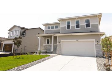 Charming two-story home with a manicured lawn, inviting front porch, and a two-car garage, offering comfort and curb appeal at 3427 Cade Ct, Castle Rock, CO 80104