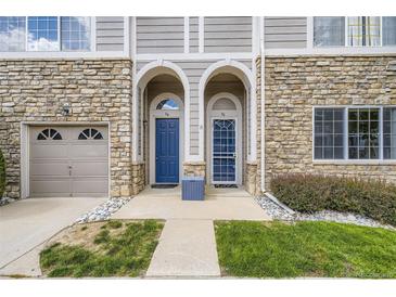 Charming townhouse facade with stone accents, arched entryways, and well-maintained landscaping at 4221 S Blackhawk Cir # 7G, Aurora, CO 80014