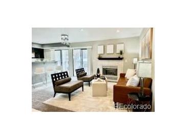 Bright living room features a fireplace and sliding glass doors at 9680 Brentwood Way # 203, Broomfield, CO 80021