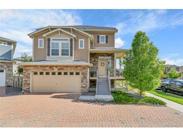 Beautiful two-story home with a brick driveway and a two-car garage at 240 S Oak Hill St, Aurora, CO 80018