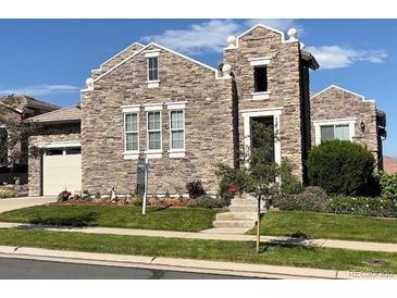 Charming stone home with a manicured lawn and a well-maintained landscape in a suburban neighborhood at 12121 Bryant St, Westminster, CO 80234