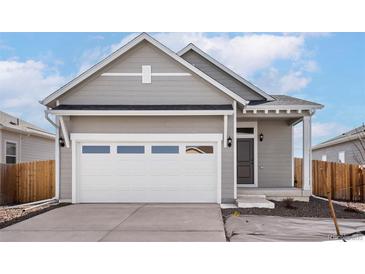 Charming single-Gathering home features a two-car garage, neutral paint, and well-maintained landscaping at 9465 Yampa St, Commerce City, CO 80022