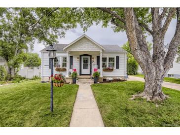 Charming home with beautiful landscaping, flower boxes, rocking chairs, and a welcoming entrance at 2634 S Humboldt St, Denver, CO 80210