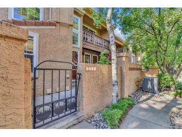 Charming home exterior with gated entrance and well-maintained landscaping at 8747 Mesquite Row, Lone Tree, CO 80124