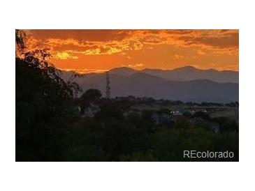 Picturesque sunset view with silhouette of distant mountains at 8627 Gold Peak Pl # C, Highlands Ranch, CO 80130
