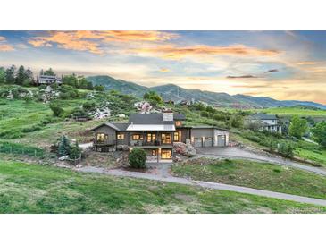 Stunning two-story home nestled in a hillside setting with mountain views and attached two car garage at 12947 Lazy Dog Ln, Littleton, CO 80127