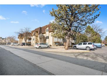 Attractive exterior of a multi-unit building with ample parking at 7455 E Quincy Ave # 204, Denver, CO 80237