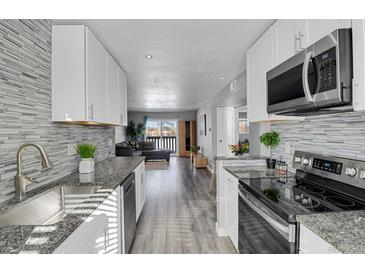 Modern kitchen with granite countertops and stainless steel appliances at 3550 S Harlan # 144, Denver, CO 80235