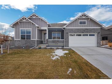 Ranch-style home with gray siding, white trim, and a two-car garage at 1680 Rivergate Way, Berthoud, CO 80513