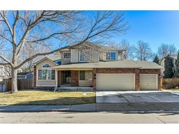 Charming two-story home with a brick facade and a three-car garage at 1642 S Trenton St, Denver, CO 80231