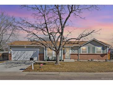 Charming single-story home with a well-manicured lawn, a two-car garage and inviting curb appeal at 12500 Meade Ct, Broomfield, CO 80020