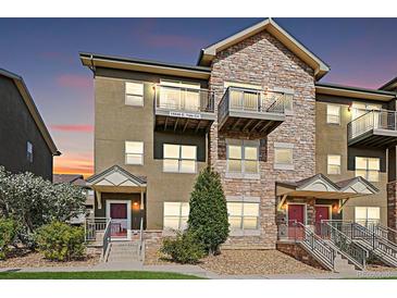 Stylish three-story townhome with a stone facade, a balcony, and a private entrance, situated in a desirable community at 18846 E Yale Cir # A, Aurora, CO 80013