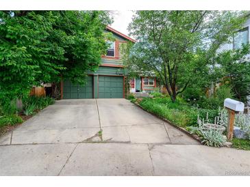 Charming two-story home with a lush front yard and attached two car garage at 3982 Arbol Ct, Boulder, CO 80301