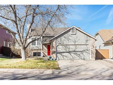 Charming two-story home with a two-car garage and a well-manicured lawn in a suburban neighborhood at 9905 Foxhill Cir, Highlands Ranch, CO 80129