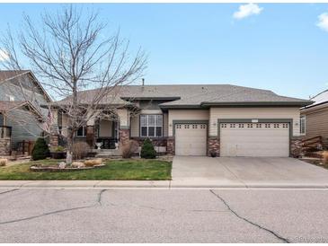 Charming single-Gathering home with a three-car garage, well-maintained lawn, and welcoming front porch at 8501 Hackamore Rd, Littleton, CO 80125