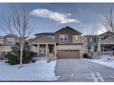 Two-story house with a large front yard, driveway, and attached garage at 15726 E Otero Cir, Centennial, CO 80112