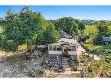 Charming single-Gathering home with mature trees, quaint front yard, and inviting curb appeal at 11475 Us Highway 85, Littleton, CO 80125