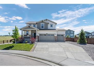 Charming two-story home with a three-car garage and a well-manicured lawn at 918 Honey Berry Ct, Elizabeth, CO 80107