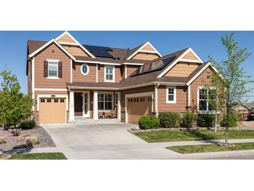 Charming two-story home featuring a two-car garage, well-maintained lawn, and solar panels for energy efficiency at 14537 Honolulu Cir, Parker, CO 80134