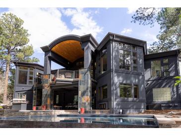 Luxury home featuring a pool, outdoor kitchen and extensive balconies with stunning architectural details at 1070 Cypress Way, Castle Rock, CO 80108