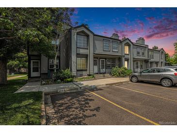 Attractive townhome featuring a gray exterior, front parking, and well-maintained landscaping at 1919 Newland Ct, Lakewood, CO 80214