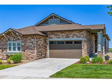 Stone-accented home with a brown two-car garage door and well-manicured front yard at 25019 E Alder Dr, Aurora, CO 80016
