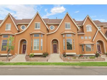 Attractive townhome featuring a unique facade, well-maintained landscaping and inviting entrance steps at 18061 E Saskatoon Pl, Parker, CO 80134