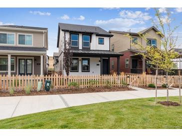 Charming two-story home featuring a black and white design and a classic picket fence at 125 Mesa Way, Superior, CO 80027