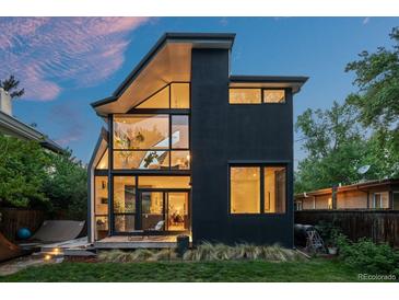 Contemporary home boasting a unique architectural design with expansive windows and a lush green lawn at 360 S Ogden St, Denver, CO 80209
