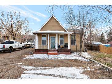 Charming single-story home featuring a cozy front porch, classic architecture, and front yard at 14050 W 8Th Ave, Golden, CO 80401