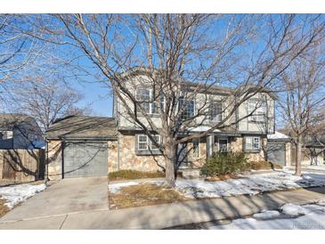 Two-story townhome with stone accents and attached garage at 10219 Vine Ct, Thornton, CO 80229