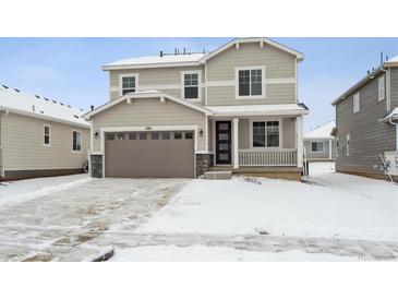 Two-story house with attached garage and snow-covered front yard at 1382 Rock Cliff Ave, Erie, CO 80516