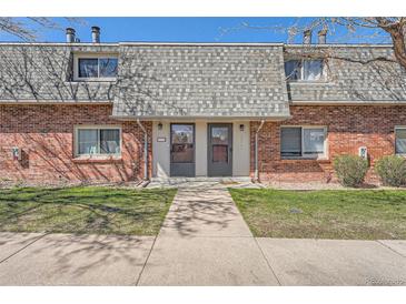 Charming brick townhouse with a well-maintained lawn and inviting entrance at 15139 E Wesley Ave, Aurora, CO 80014