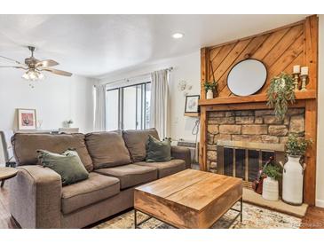 Cozy living room featuring a fireplace and ample seating at 4896 S Dudley St # 7-7, Littleton, CO 80123