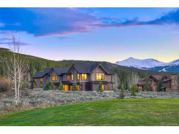Stunning exterior view of a modern home with mountain views and well manicured lawn at 294 Gold Run Rd, Breckenridge, CO 80424