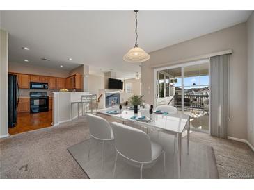 Inviting dining area adjacent to the kitchen, with sliding glass doors to the patio for seamless indoor-outdoor living at 74 Whitehaven Cir, Highlands Ranch, CO 80129