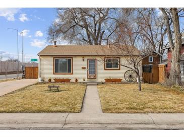 Ranch style home with landscaped yard and walkway at 4825 Estes St, Arvada, CO 80002