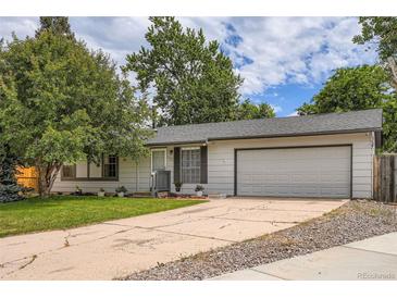 Charming single story home featuring an attached two car garage and mature landscaping at 3358 S Iris Ct, Lakewood, CO 80227
