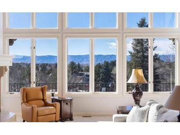 Bright living room with large windows and mountain views at 73 Falcon Hills Dr, Highlands Ranch, CO 80126