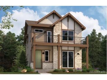 Charming two-story home featuring a stone facade, balcony, and a welcoming green front lawn at 3864 W 82Nd Ln, Westminster, CO 80031