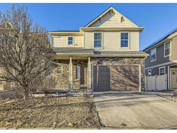 Inviting two-story home with stone accents, neutral siding, and an attached two-car garage at 18241 E 47Th Dr, Denver, CO 80249