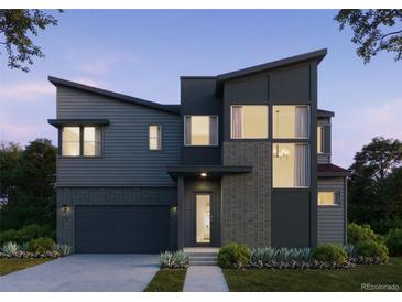 Modern two-story home with dark siding, brick accents, and a two-car garage at 11499 Alla Breve Cir, Lone Tree, CO 80134