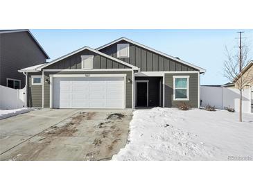 Gray exterior house with white garage door and snowy front yard at 507 Bonneville Ave, Fort Lupton, CO 80621